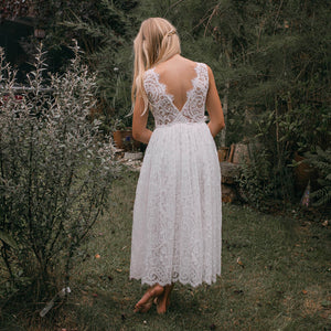 Flower girl in a Beautiful white lace dress