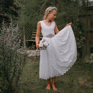 Flower girl in a Beautiful white lace dress