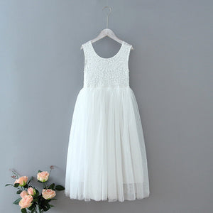 White lace dress on a hanger with flowers on a gray background