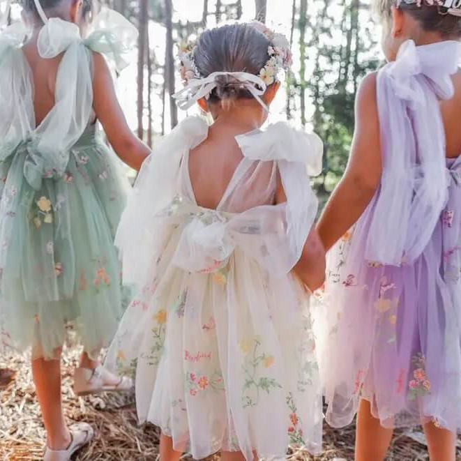 3 young girls wearing pretty dresses