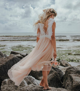 YOUNG GIRL STANDING ON A BEACH
