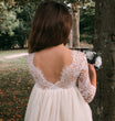 young girl holding flowers by tree