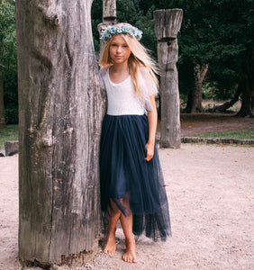 young girl wearing a navy blue flower girl dress