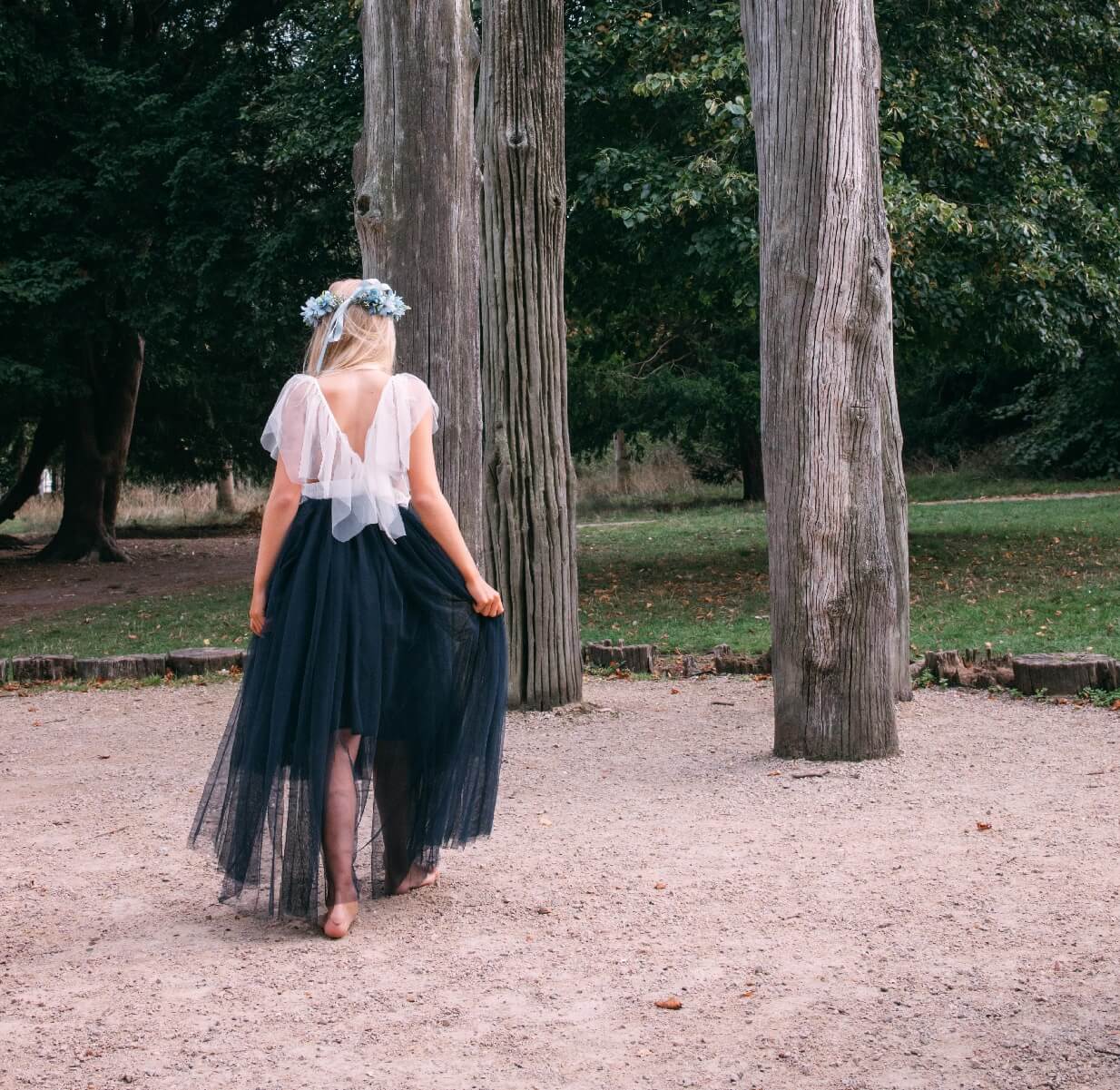 young girl wearing a navy blue flower girl dress