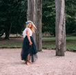 young girl wearing a navy blue flower girl dress