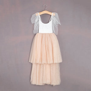 Two-tone dress with white top and beige skirt on a hanger against a gray background