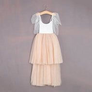 Two-tone dress with white top and beige skirt on a hanger against a gray background