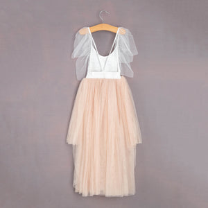Two-tone dress with white top and beige skirt on a hanger against a gray background