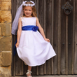 flower girl wearing a white dress with a blue sash