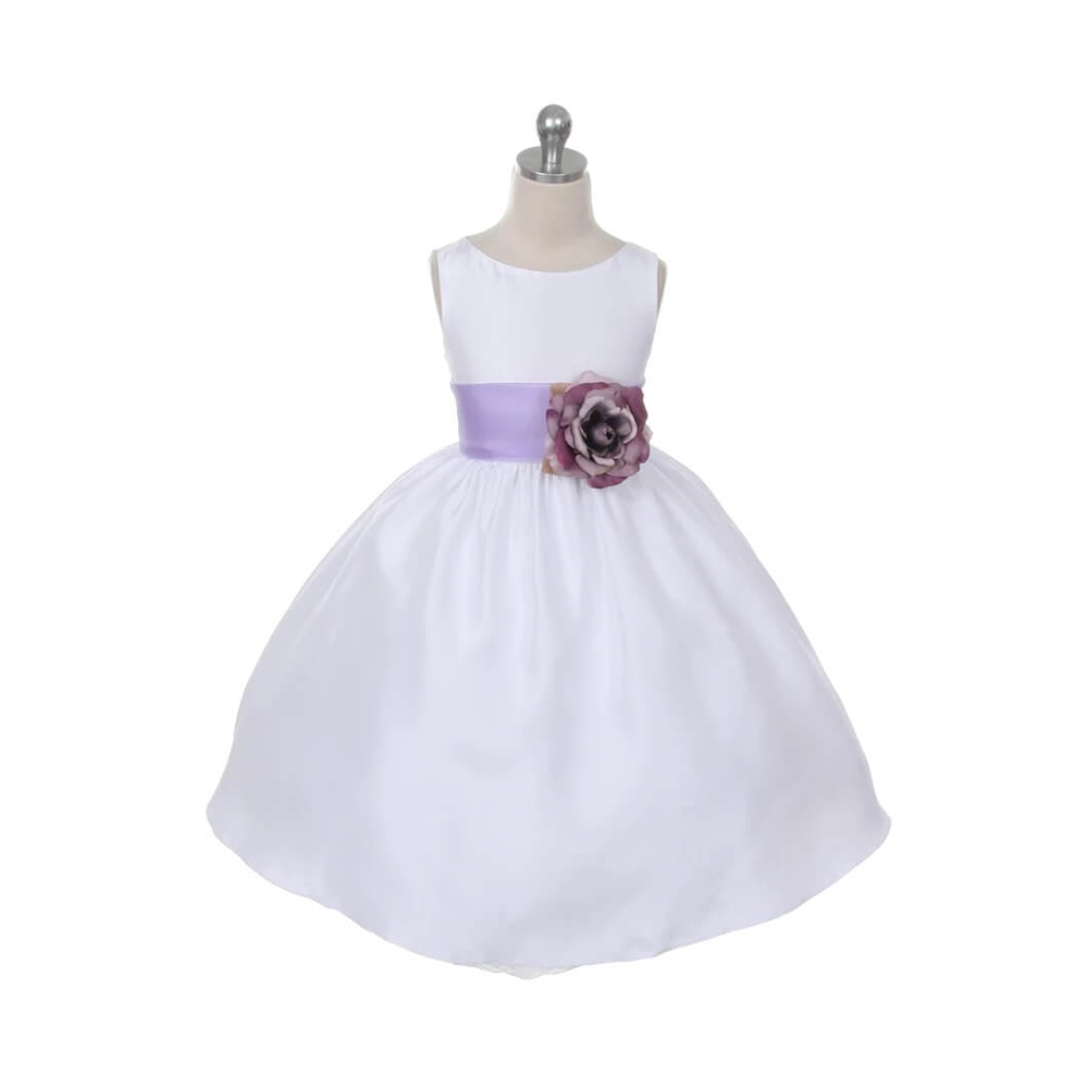 White flower girl dress with a heather coloured sash and flower