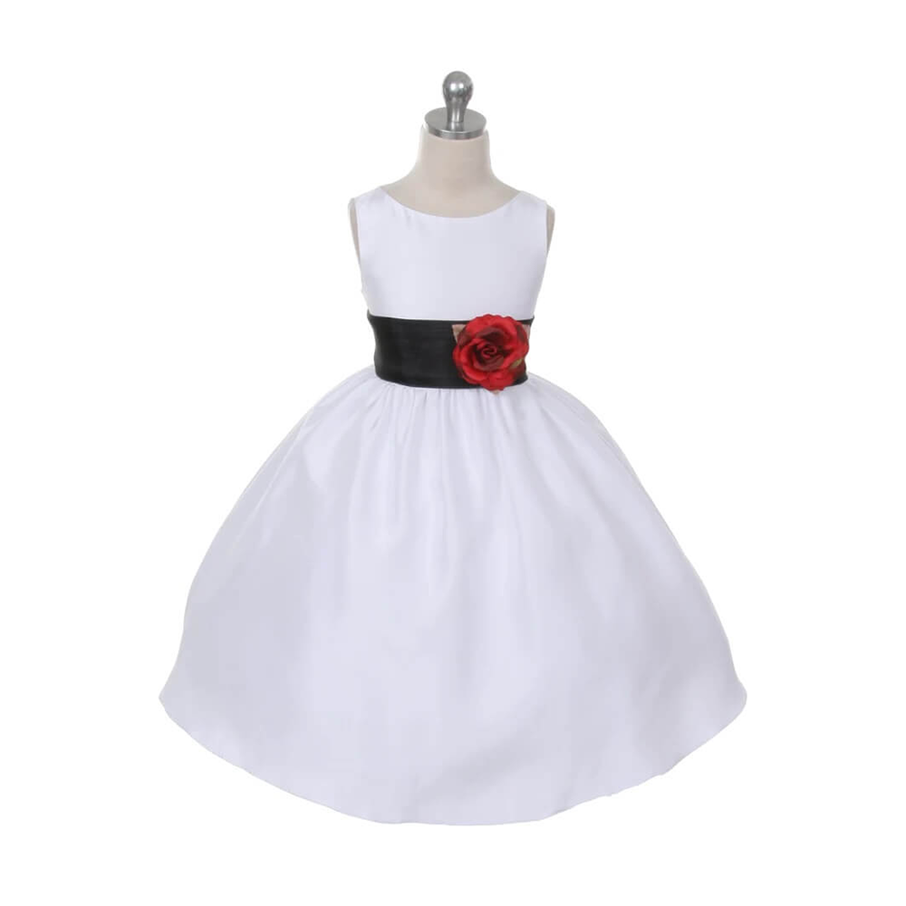 white flower girl dress with flower girl wearing a white dress with a black sash and flower