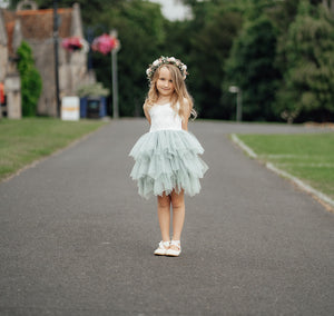 Young girls wearing dress smiing