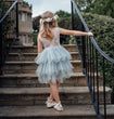 Young girls wearing dress walking up stairs
