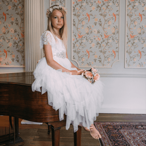 Girl wearing dress and holding flower bouquet