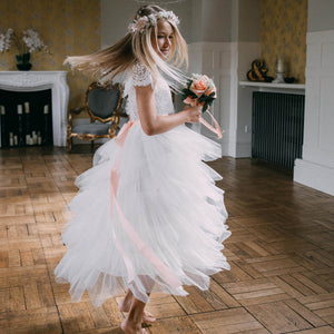 Girl wearing dress and holding flower bouquet