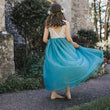 young girl wearing a teal flower girl dress