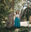 young girl wearing a teal flower girl dress