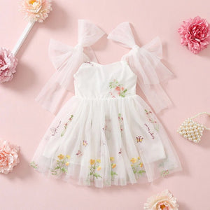 white dress with pretty bow shoulder ties and embroidery