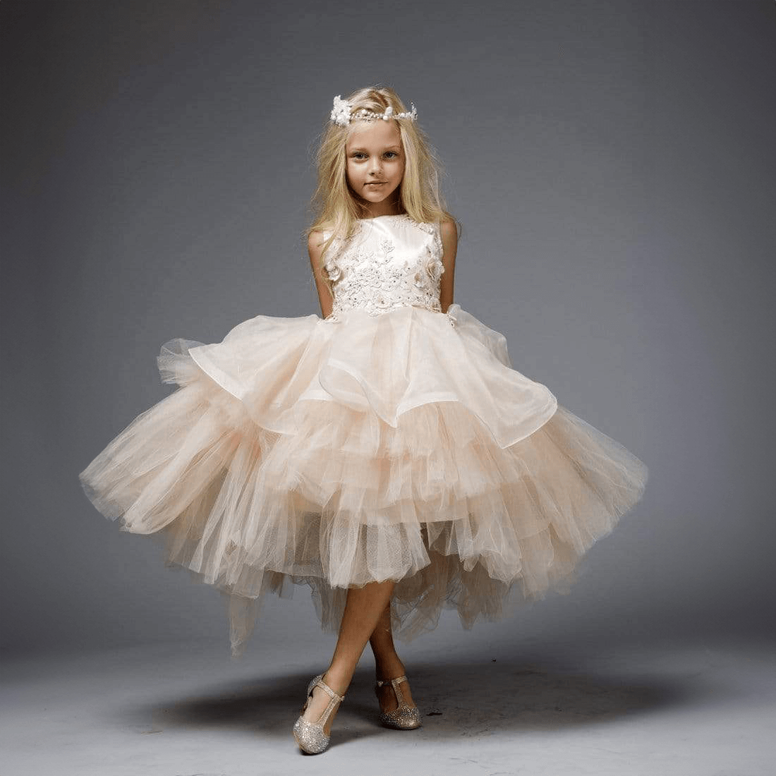 Girl wearing a blush coloured Princess Evangeline party dress