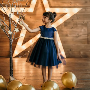 Girl wearing a navy party dress from UK Flower Girls Boutique 