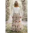 Young girl in a floral dress standing in a garden with flower decorations. Enchanted Snow Long Sleeve Dress - Chantilly Lace