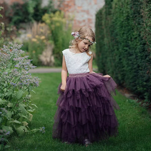 young girl holding her skirt in gardens