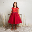 girl wearing a red party Dress from uk flower girl boutique