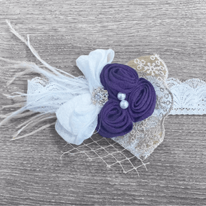purple head piece with feather and flowers
