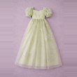 Light green dress with floral embroidery on a purple background