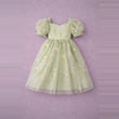 A light green tulle dress for girls, featuring puff sleeves, a sweetheart neckline, and delicate floral embroidery, displayed against a textured lavender background.