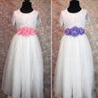 White dresses with pink and purple sash corsages