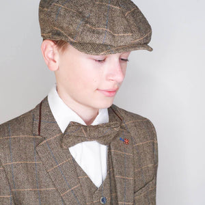 Young teen wearing suit and cap