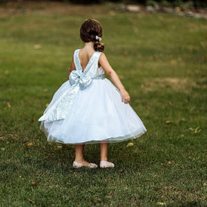 Girl standing on grass in silver uk flower girl dress