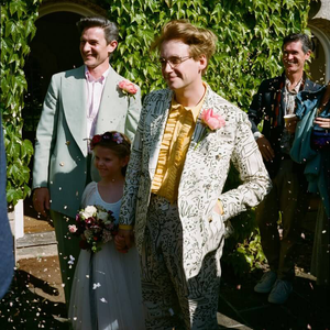 Two men getting married with flower girl