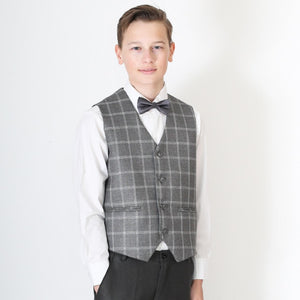 Young boy wearing waistcoat and suit trousers