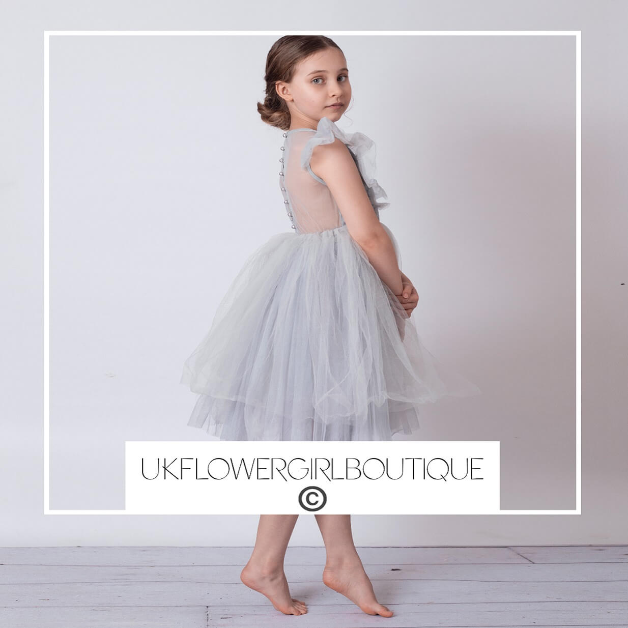 girl in silver party dress from UK Flower Girl Boutique