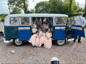 Flower girls and babies in camper van for wedding 