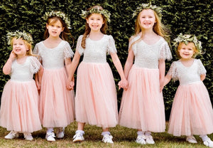 Young children wearing same pretty dress