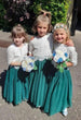 Young children holding bouquets 