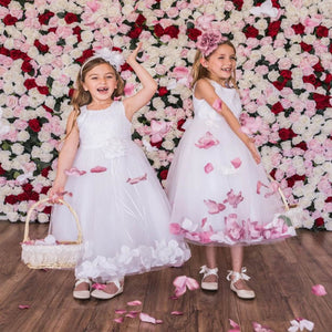 2 girls playing with petals in flower girl dresses