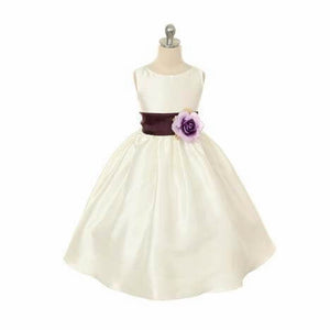 White flower girl dress with purple sash on mannequin