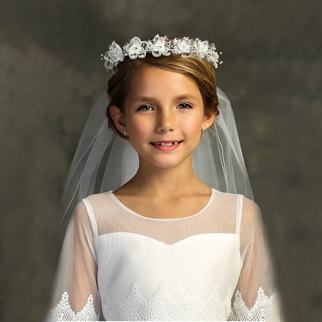 Girl in a white dress and Rhinestone Crown with Veil