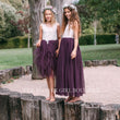 Two girls in purple dresses