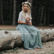 Girl sitting on log in forest