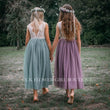 Two girls wearing similar dresses