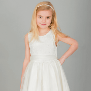 Blonde girl wearing ivory coloured party dress