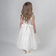 Girl wearing ivory party dress with bow on back