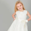 Gril winking in a white flower girl dress