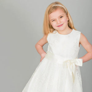 Gril winking in a white flower girl dress